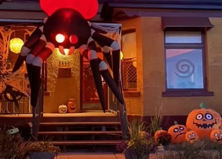 Halloween decor at Reflections Salon and Spa, Salt Lake City, Utah, US with giant inflatable spider and pumpkins.