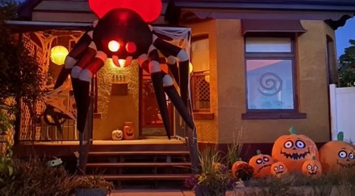Halloween decor at Reflections Salon and Spa, Salt Lake City, Utah, US with giant inflatable spider and pumpkins.