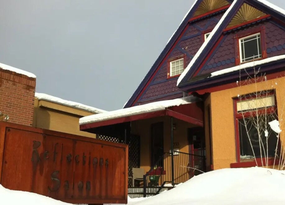 Cozy exterior of Reflections Salon and Spa in snow-covered Salt Lake City, Utah, US.