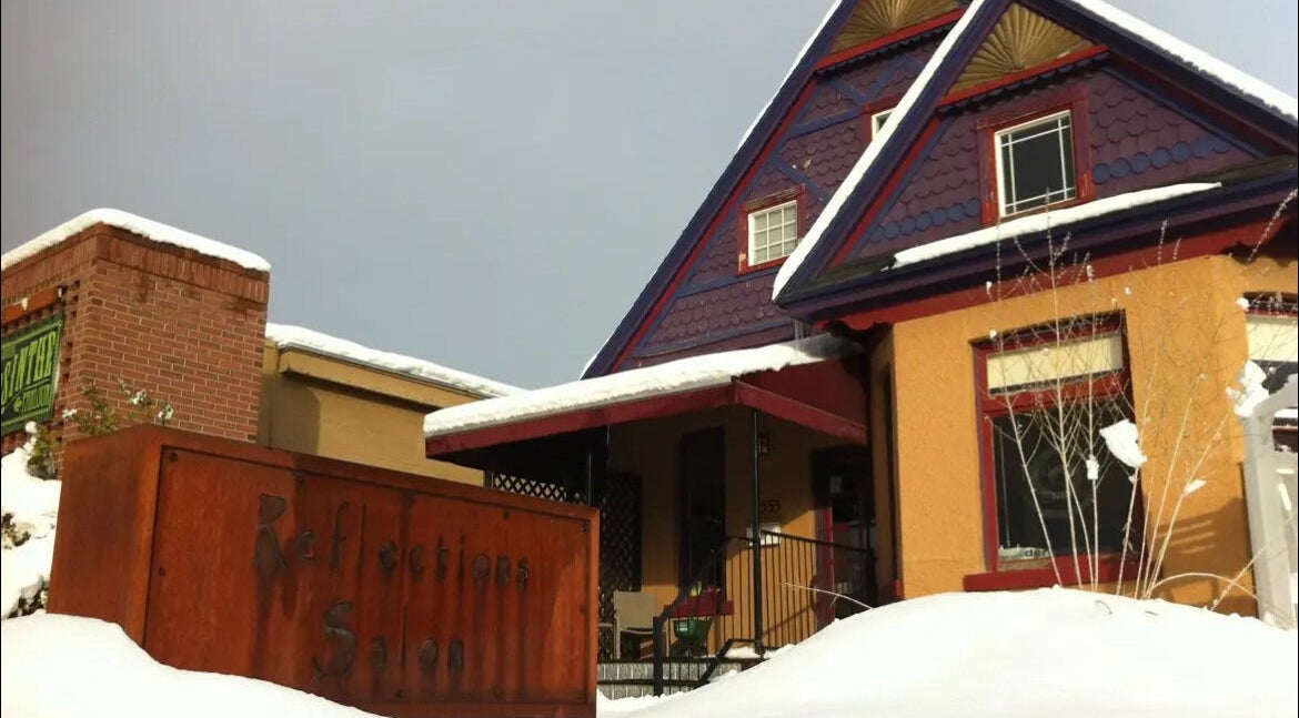 Cozy exterior of Reflections Salon and Spa in snow-covered Salt Lake City, Utah, US.