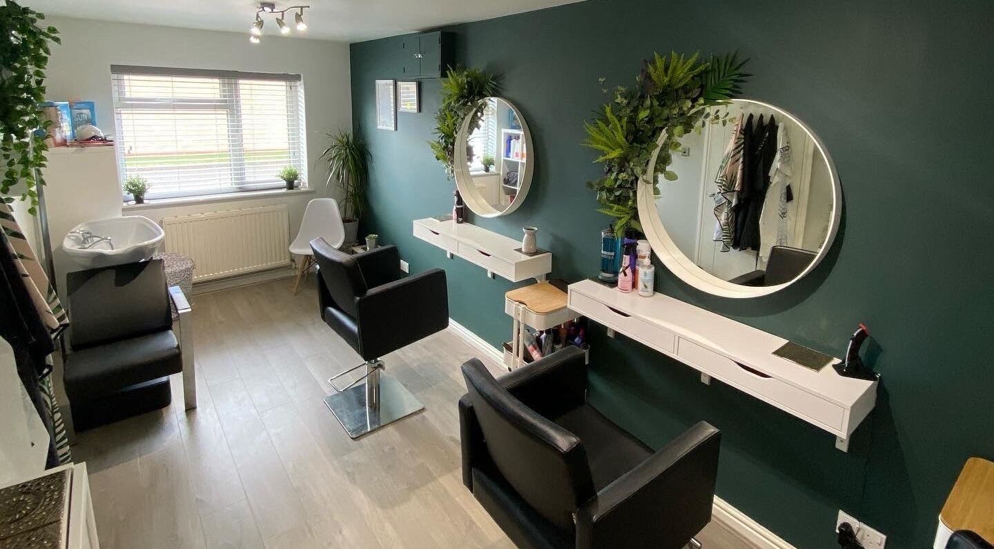 Modern salon interior at Laura Fuller Freelance Stylist, Evesham, England, GB, featuring stylish chairs and mirrors.