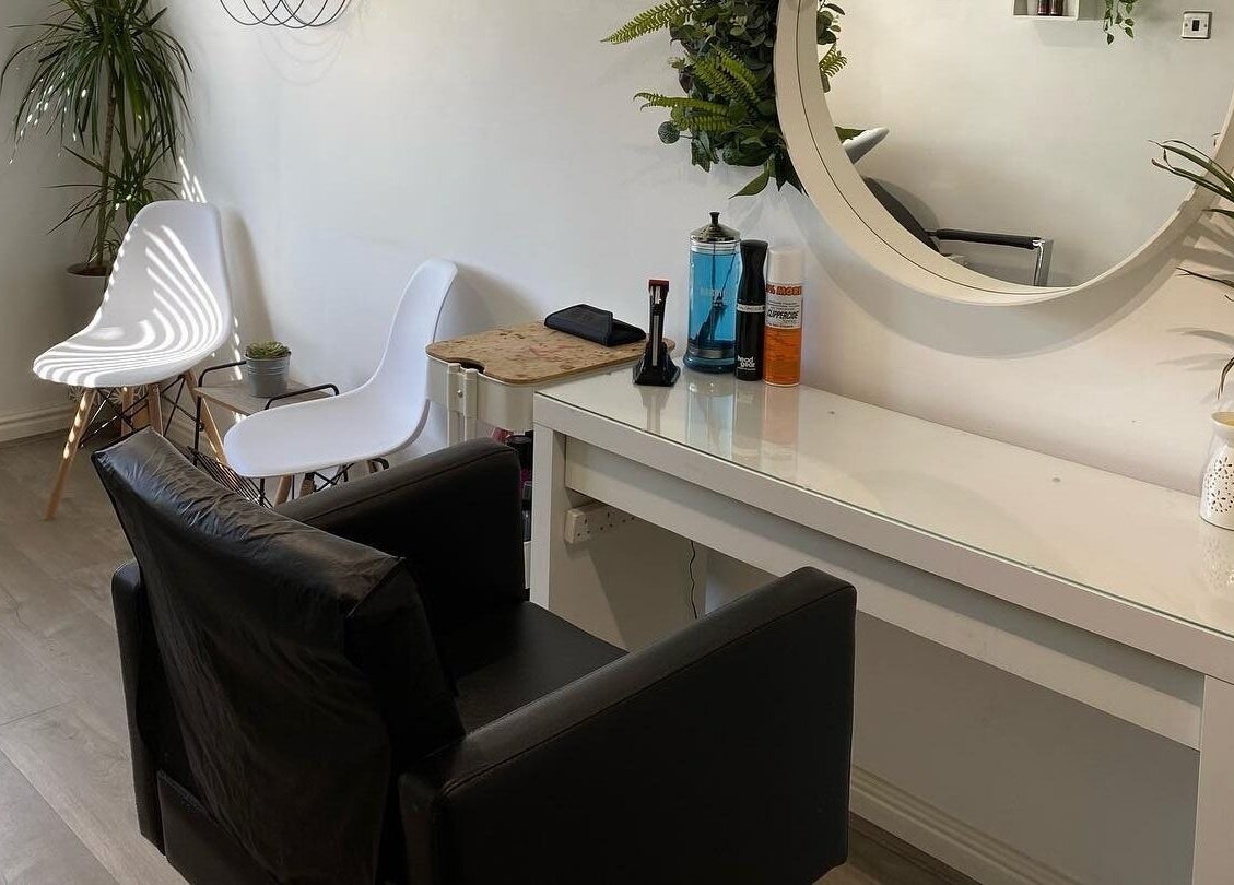 Modern salon interior at Laura Fuller Freelance Stylist in Evesham, England, GB with chic decor and seating.
