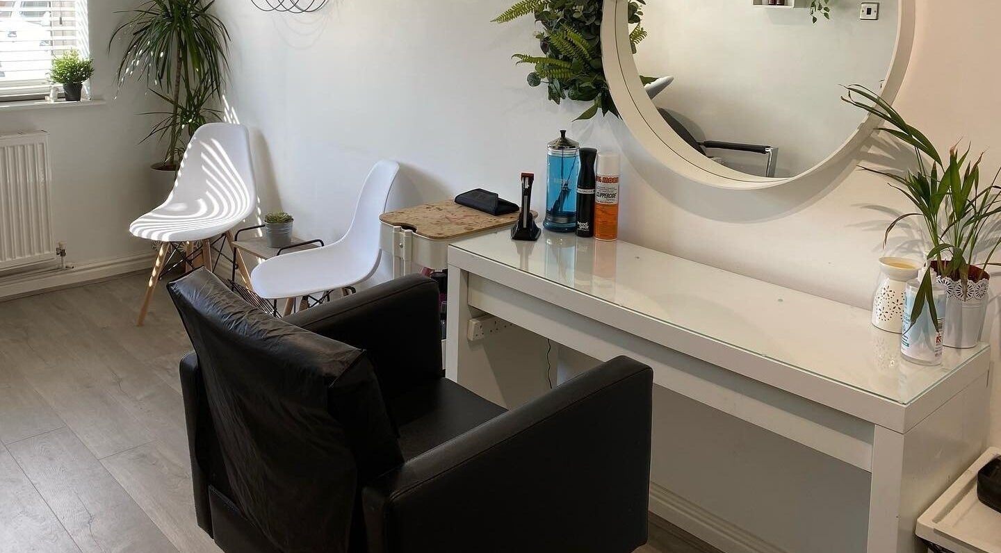 Modern salon interior at Laura Fuller Freelance Stylist in Evesham, England, GB with chic decor and seating.