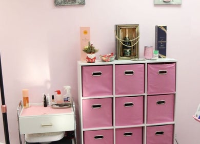 Stylish storage at Millennium Beauty Studio, New York, New York, US with pink decor and beauty products.