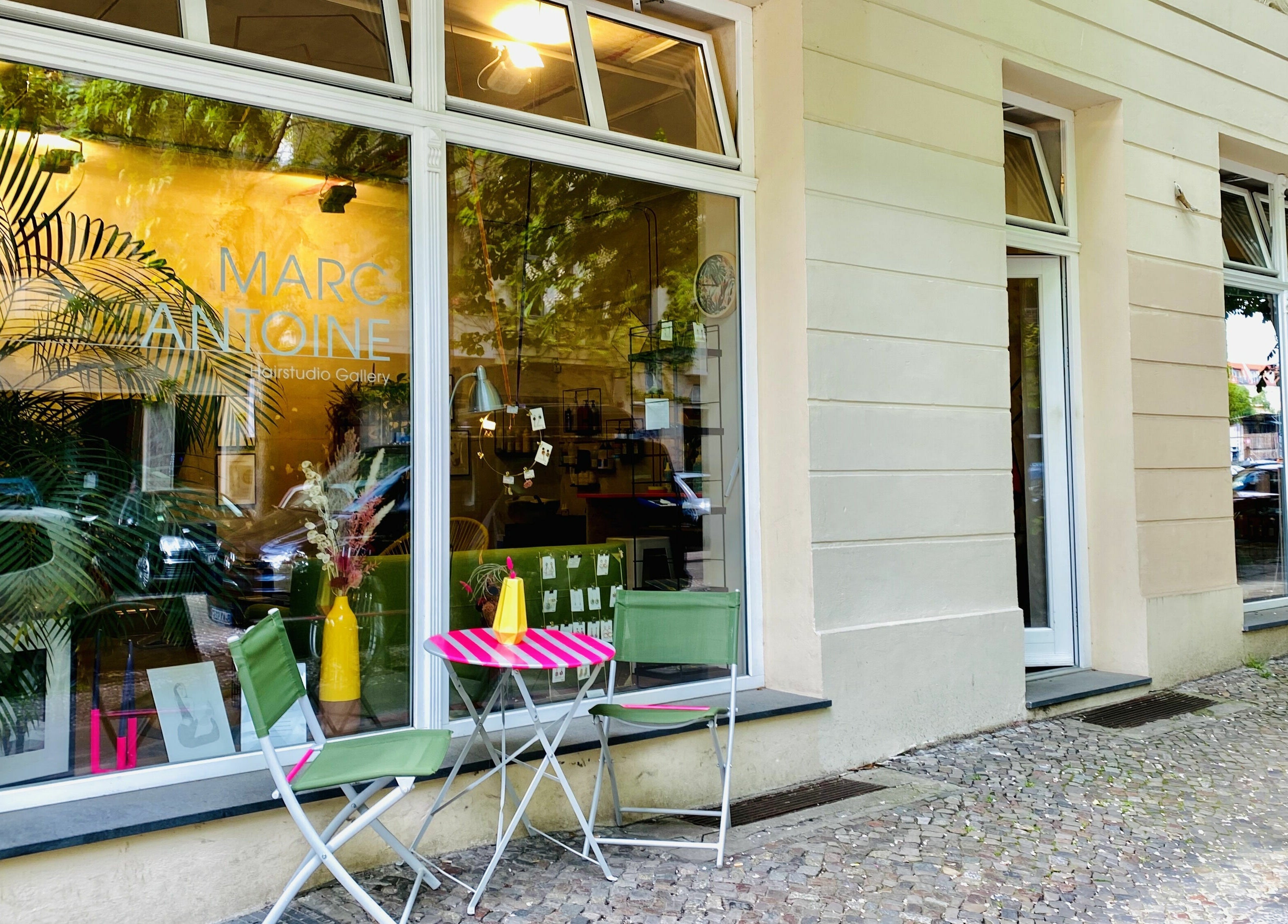 Exterior of Marc-Antoine Hairstudio Gallery in Berlin, Berlin, DE. Features stylish outdoor seating and large windows.