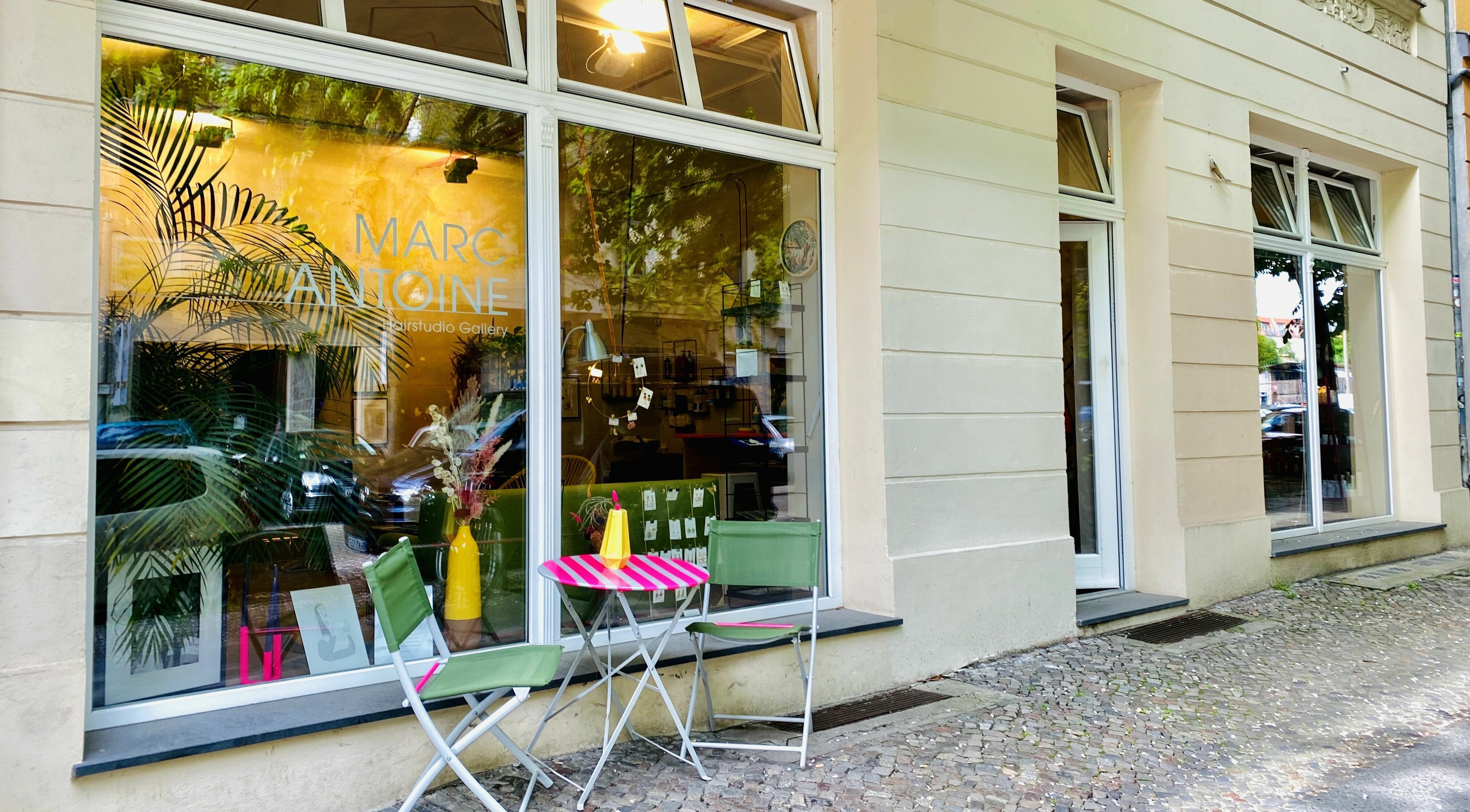 Exterior of Marc-Antoine Hairstudio Gallery in Berlin, Berlin, DE. Features stylish outdoor seating and large windows.