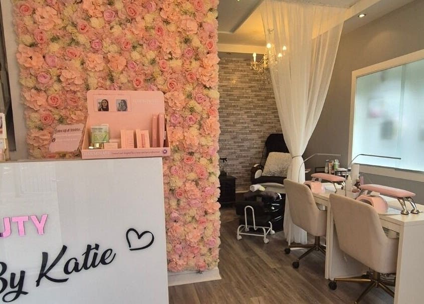 Beauty and Body By Katie in Castleisland, County Kerry, IE showcases a floral wall and modern salon seating.