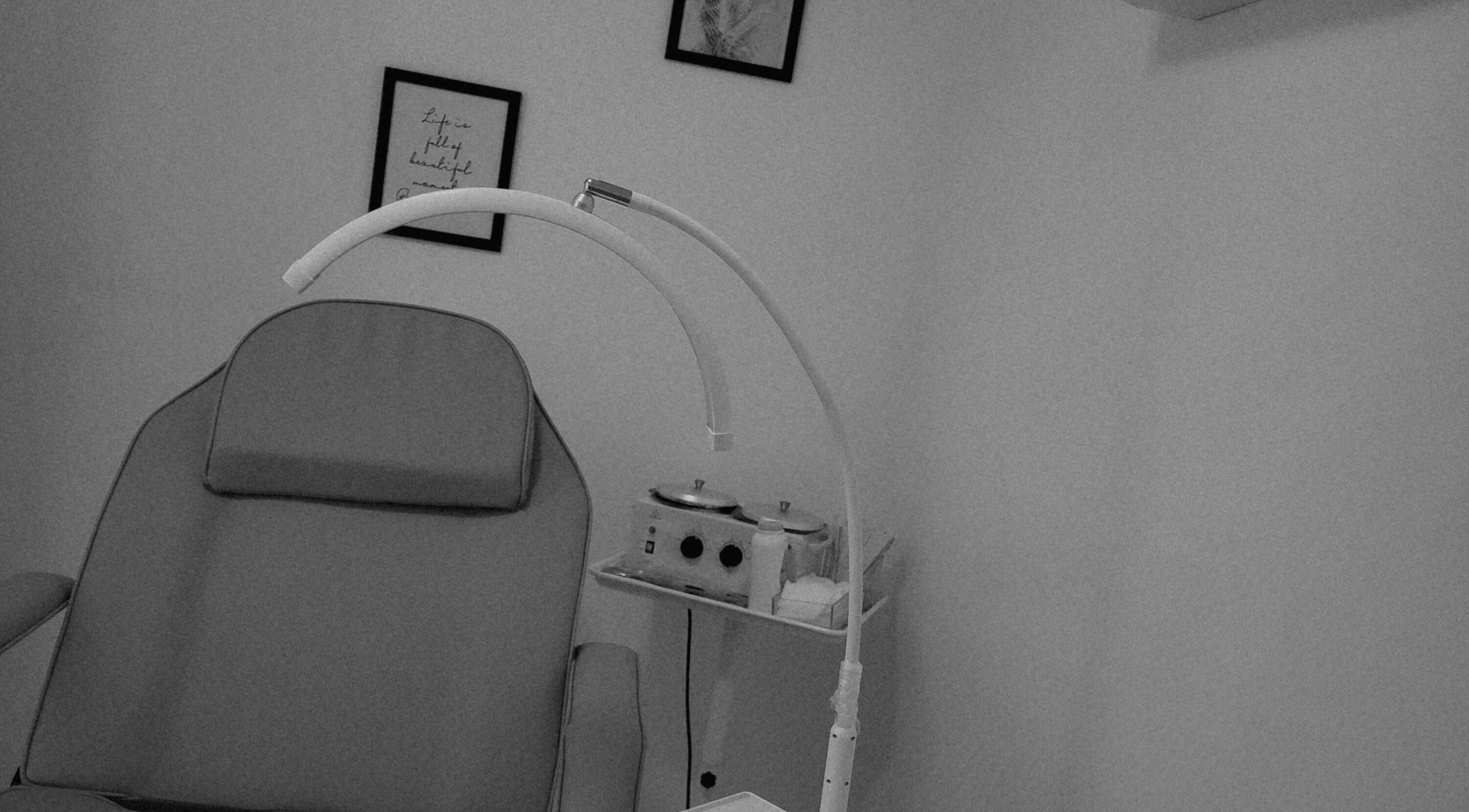 Ndya's Beauty Loft spa room with treatment chair in Nassau, New Providence, BS. Minimalist and soothing decor.