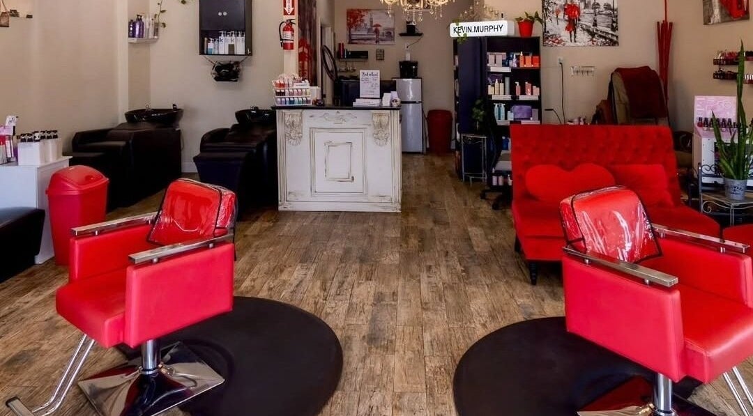 Inside London Heights Hair & Nail Salon in Houston, Texas, US featuring trendy red chairs and elegant decor.