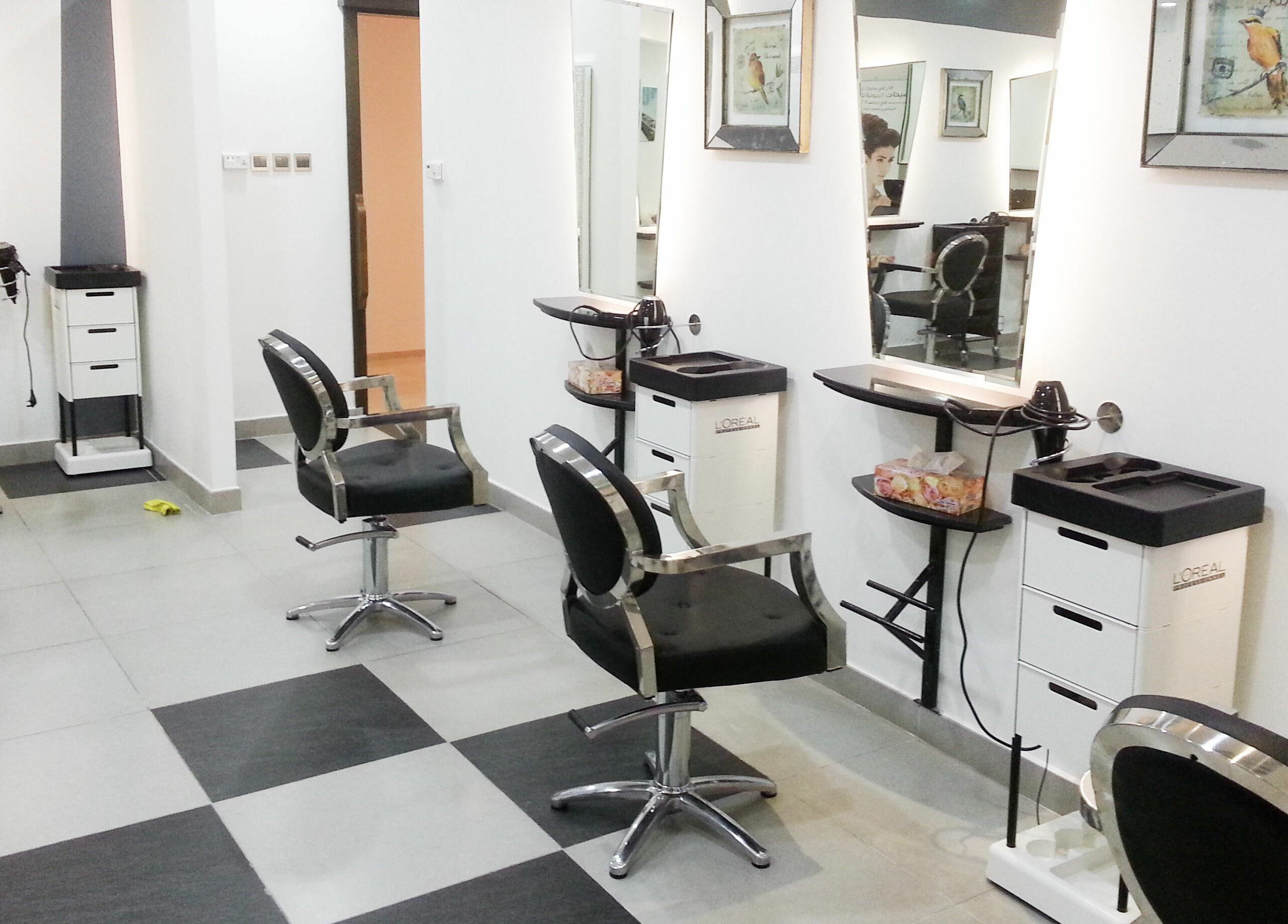Interior of MOI Beauty Salon at Ramada Hotel in Dubai, Dubai, AE featuring stylish black salon chairs and mirrors.