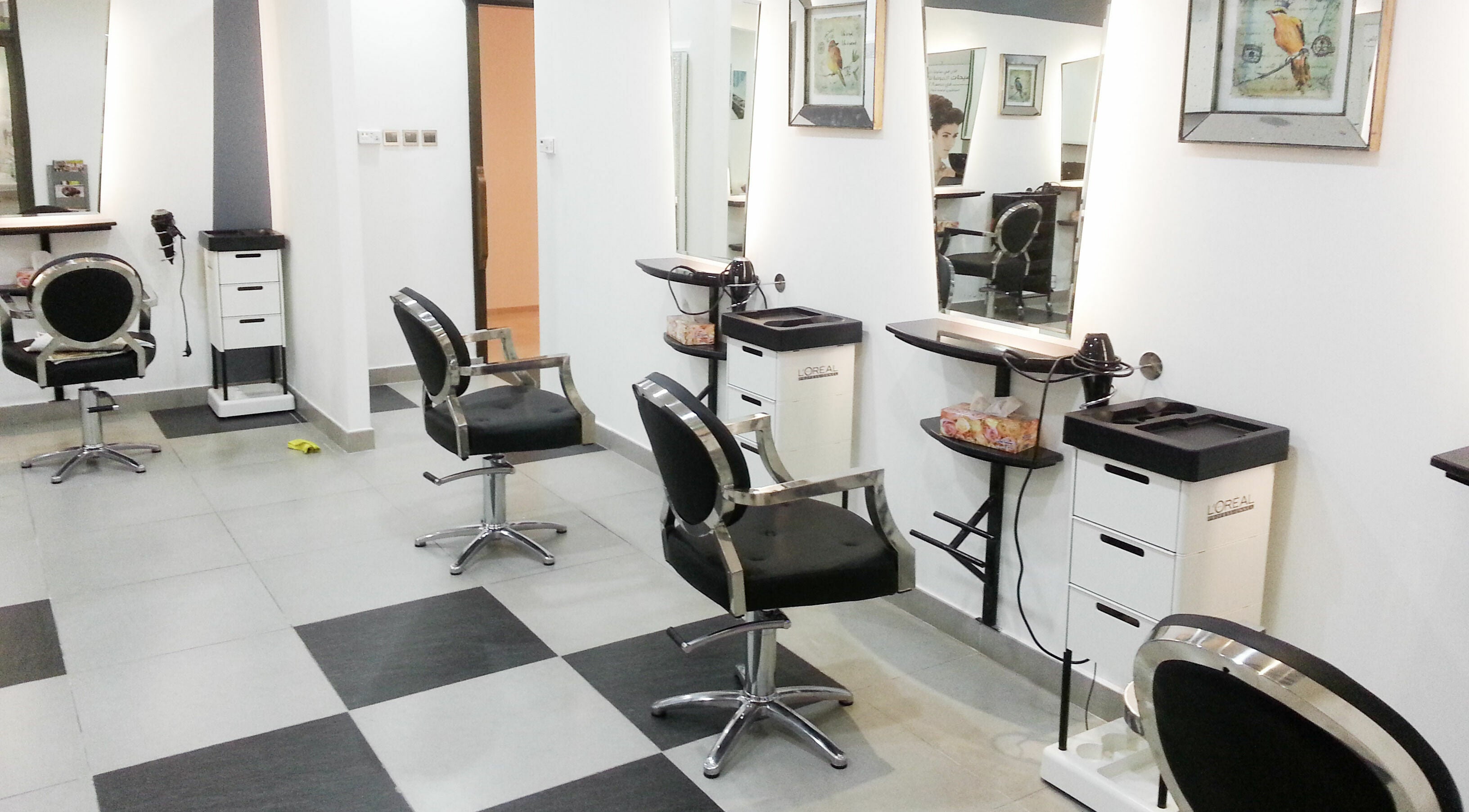 Interior of MOI Beauty Salon at Ramada Hotel in Dubai, Dubai, AE featuring stylish black salon chairs and mirrors.