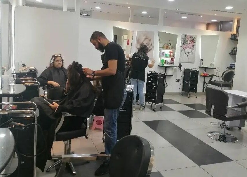 Inside MOI Beauty Salon - Ramada Hotel, Dubai. Customers receiving hair treatments in a modern, elegant setting.