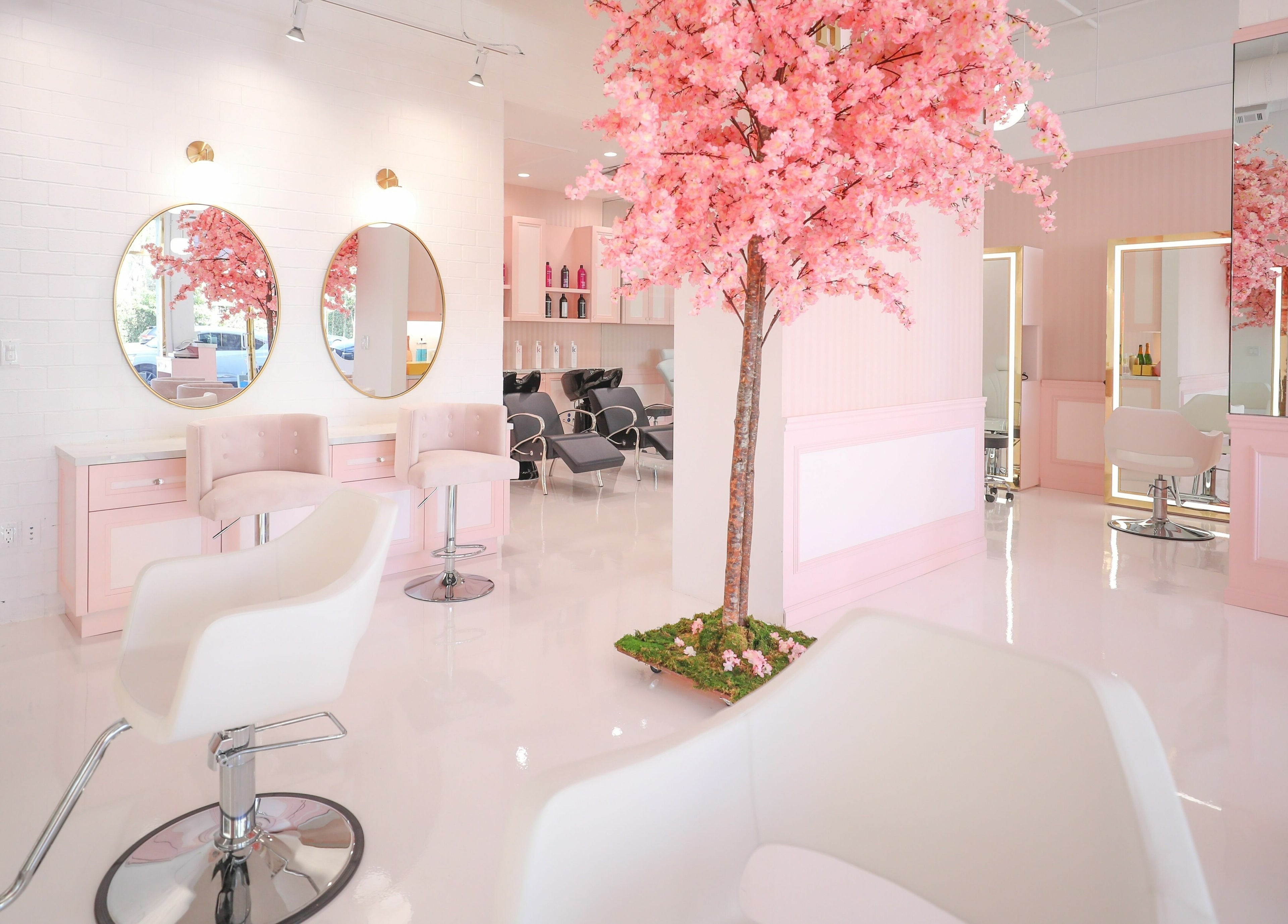 Chic interior of Brows by Alyssa HairBae Beauty Bar, Los Angeles, California, US, featuring pink decor and cherry blossoms.