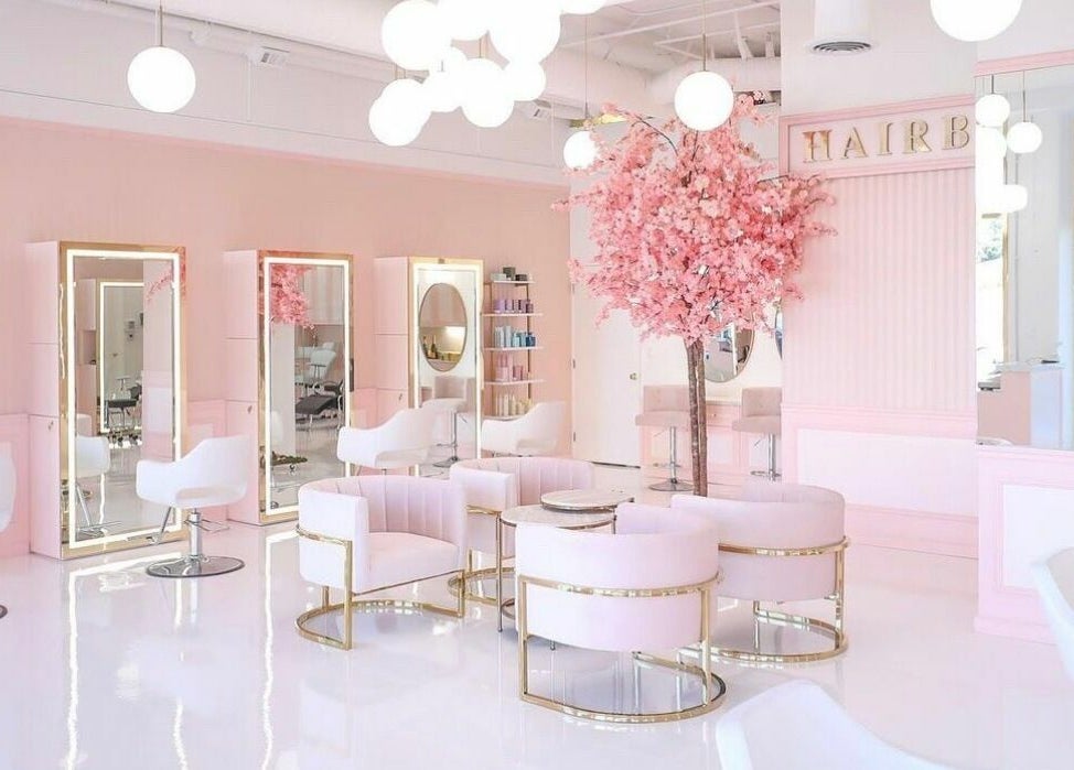 Elegant interior of Brows by Alyssa HairBae Beauty Bar in Los Angeles, California, US with pink decor and seating.