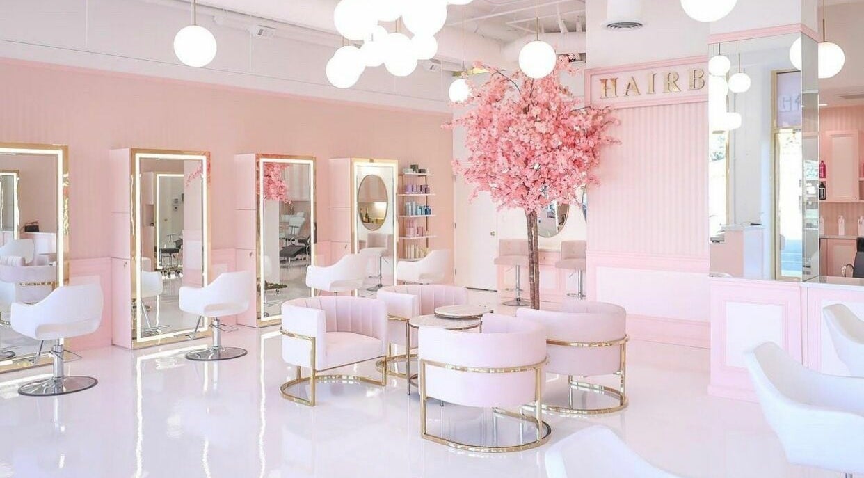 Elegant interior of Brows by Alyssa HairBae Beauty Bar in Los Angeles, California, US with pink decor and seating.