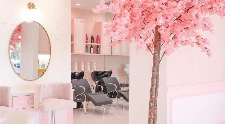 Elegant salon interior with pink blossom tree at Brows by Alyssa HairBae Beauty Bar, Los Angeles, California, US.