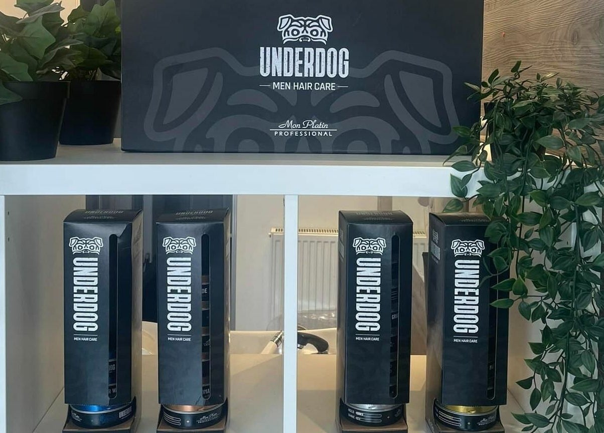 Underdog men's hair care products at Platform 169, Exeter, England, GB on a sleek shelf with decor.