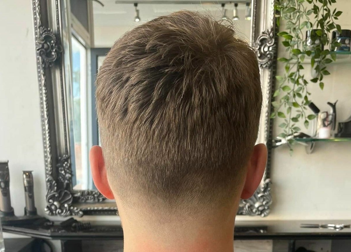 Back view of a neat haircut at Platform 169, Exeter, England, GB. Stylish mirror and decor visible.