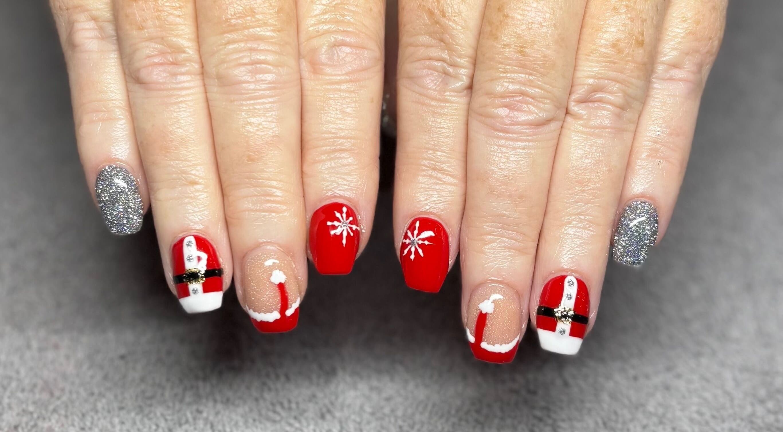 Festive red and silver nail art at Nails and Beauty at Talking Heads, Plymouth, England, GB.