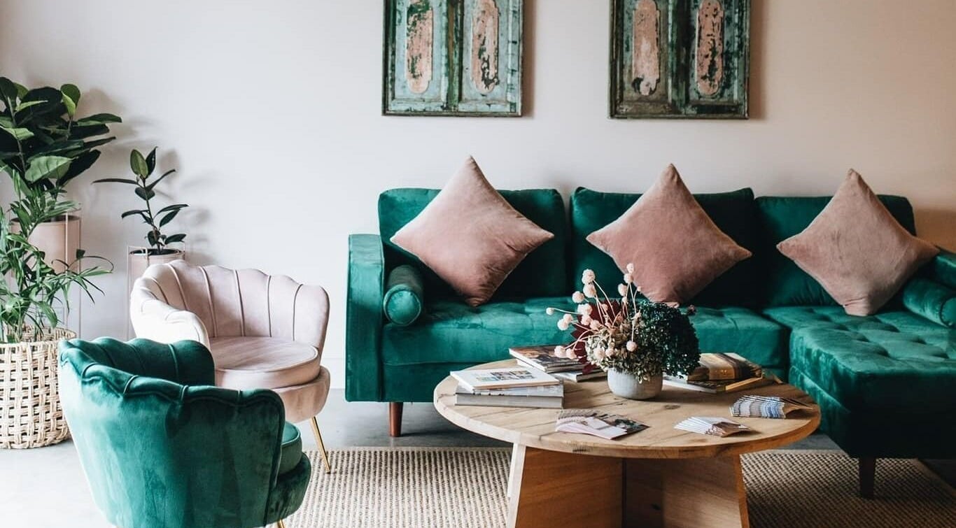 Elegant lounge area at Parlour J Health and Beauty, Jugiong, New South Wales, AU with plush green seating.