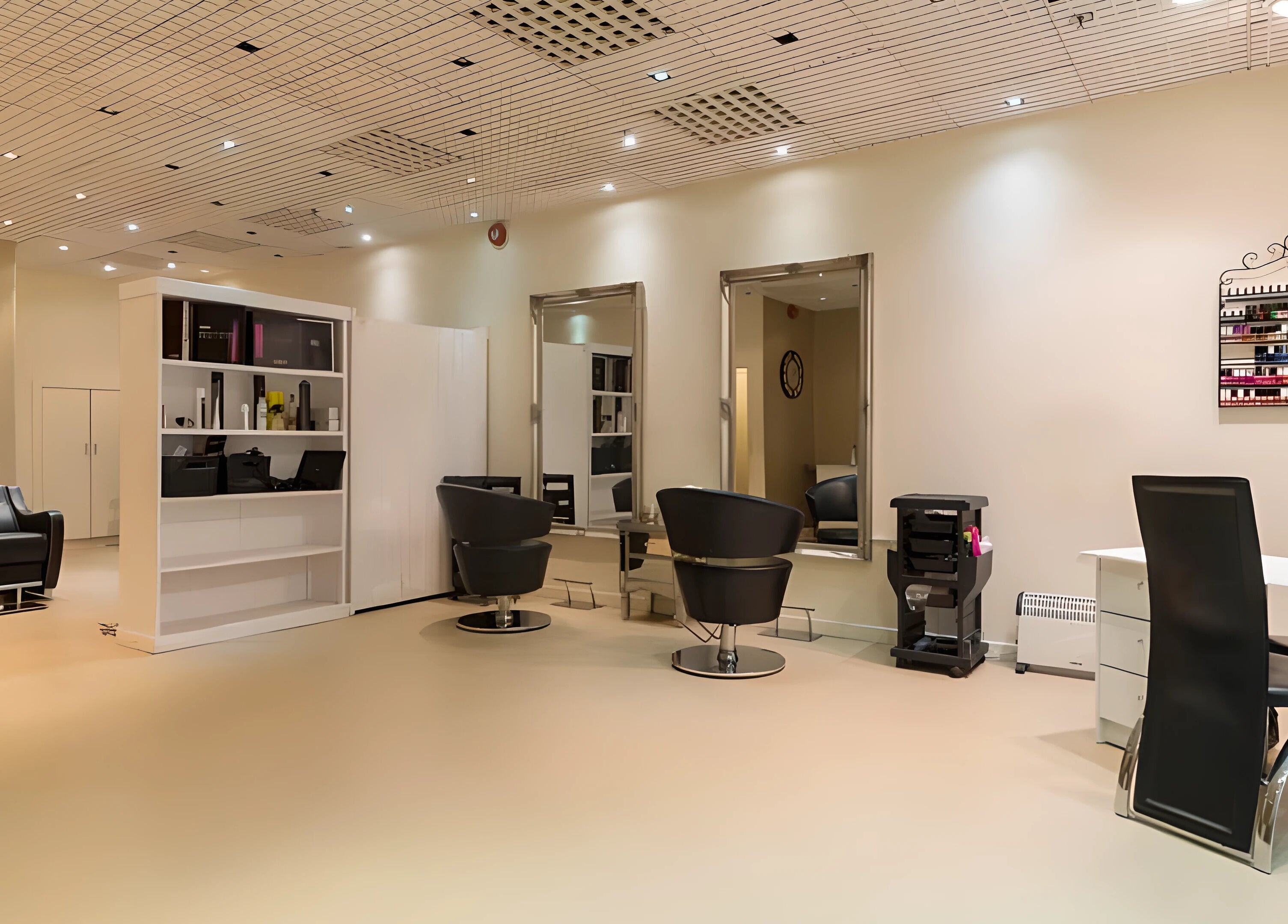 Interior view of Pampered Retreat salon in Bangor, Wales, GB showcasing modern chairs and spacious design.