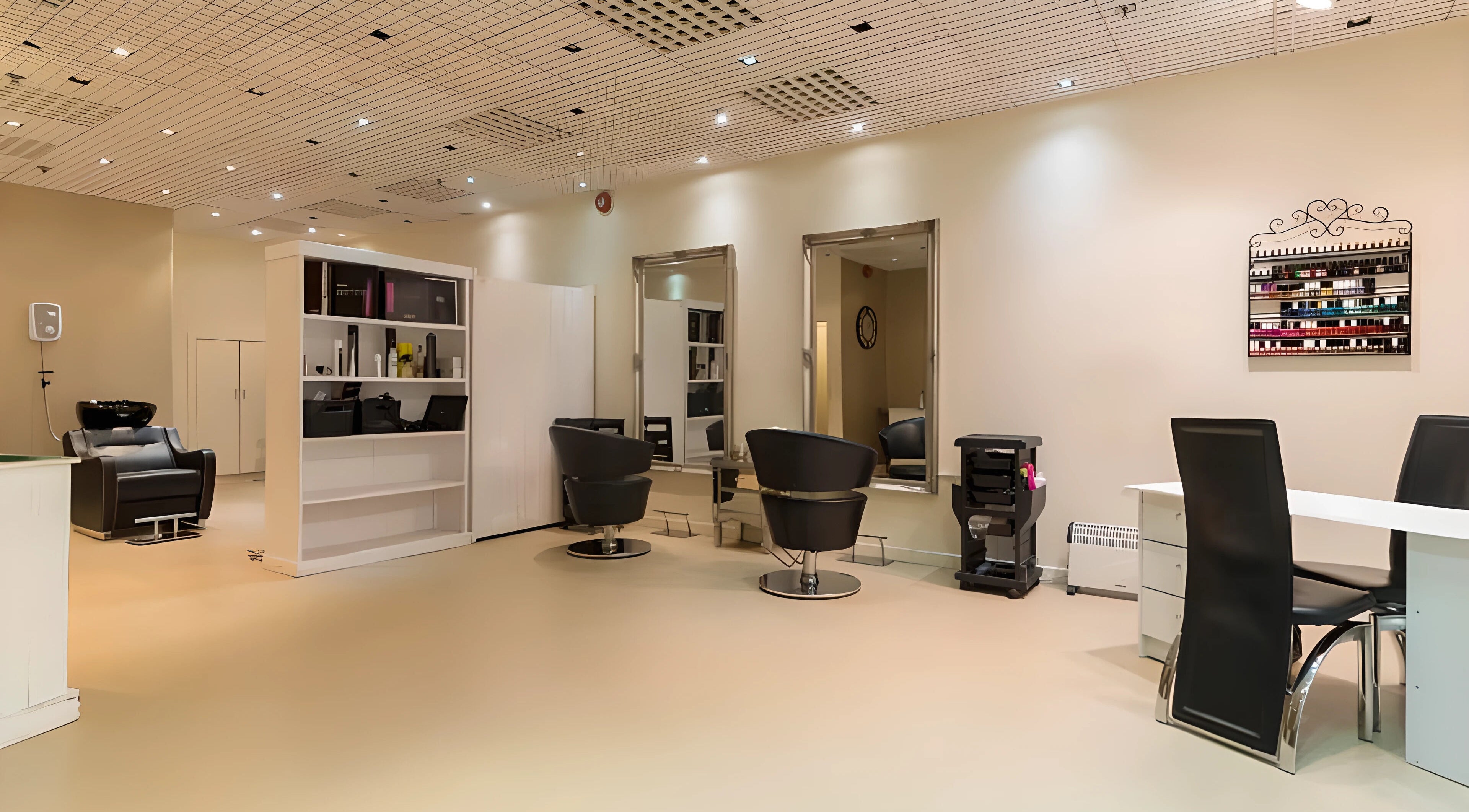 Interior view of Pampered Retreat salon in Bangor, Wales, GB showcasing modern chairs and spacious design.