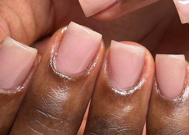 Elegant glossy nude manicure at Myrie Beauty, Whitby, Ontario, CA, showcasing professional nail artistry.