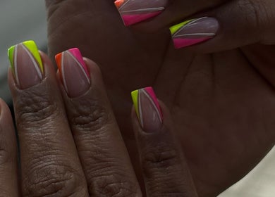 Neon nail art at Myrie Beauty, Whitby, Ontario, CA featuring bright geometric designs.