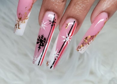 Elegant long nails with pink, white, and black snowflake design at Myrie Beauty in Whitby, Ontario, CA.