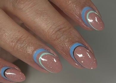 Stylish nail art design at Myrie Beauty, Whitby, Ontario, CA featuring glittery and pastel geometric patterns.