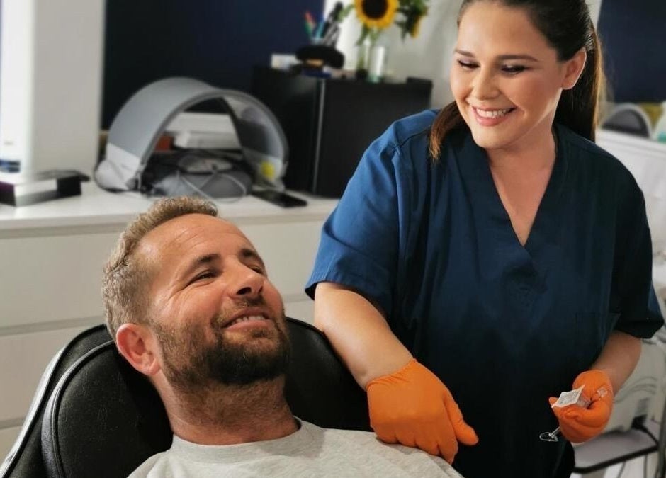 Beauty technician at Simply Ella in Chelmsford, England, GB, providing a relaxing treatment session for a male client.