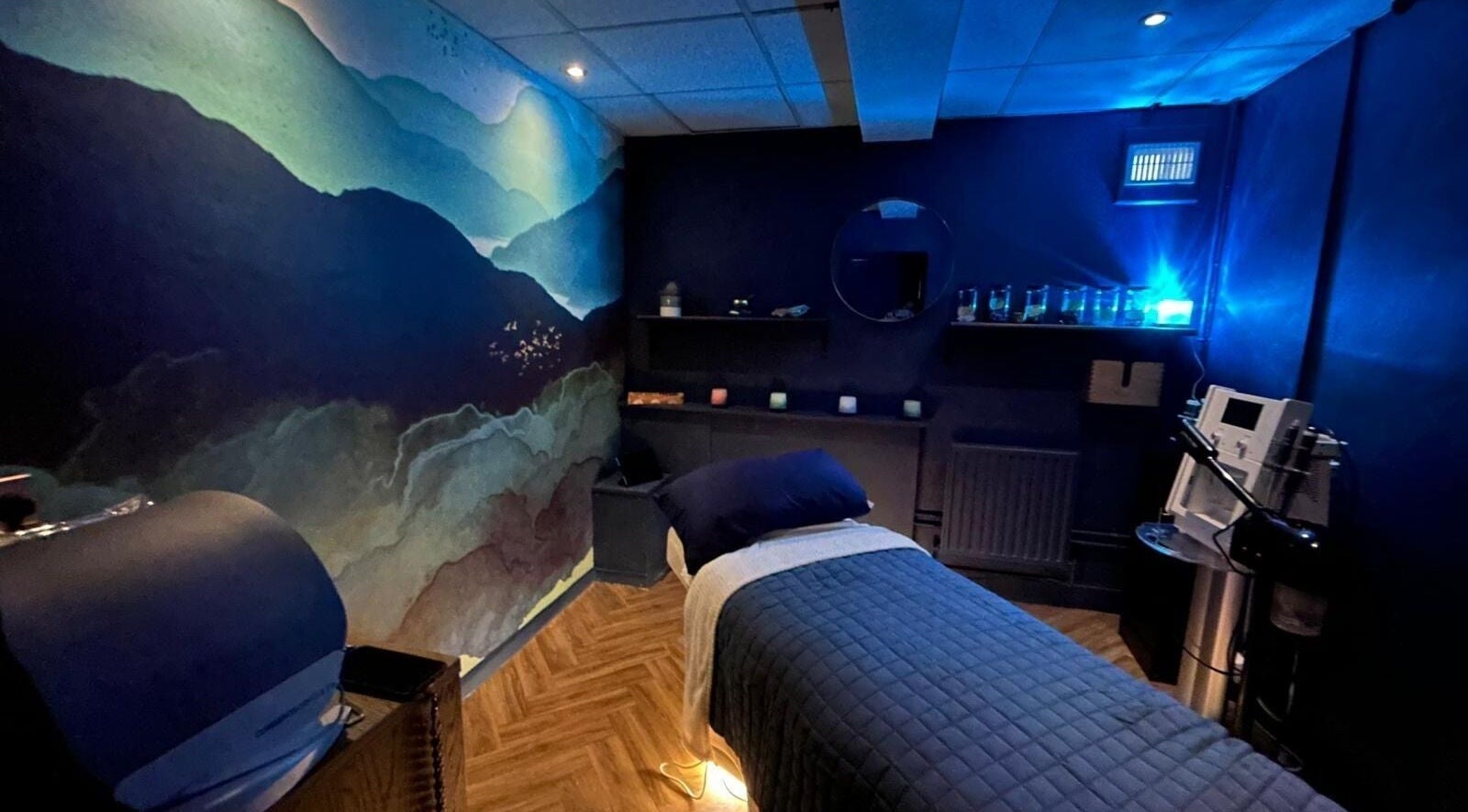 Sii Bello Collective Room 8 spa ambiance in Chelmsford, England, GB with serene wall art and cozy lighting.