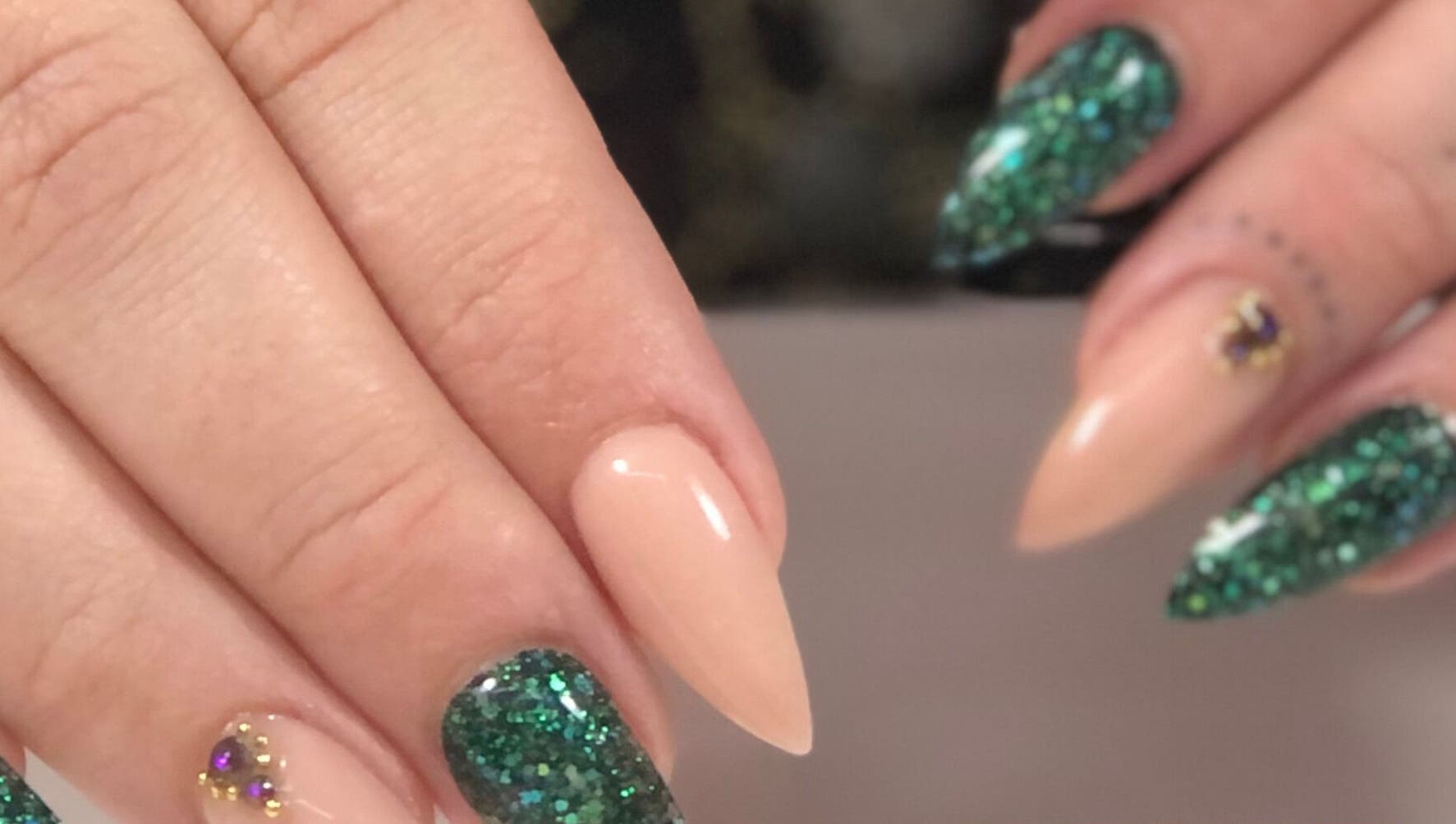 Elegant glitter nail art at Nails by D’zign, Benoni, Gauteng, ZA showcasing green and nude tones.