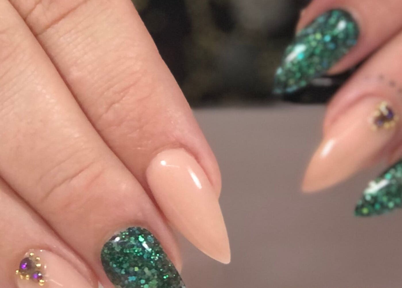 Elegant glitter nail art at Nails by D’zign, Benoni, Gauteng, ZA showcasing green and nude tones.