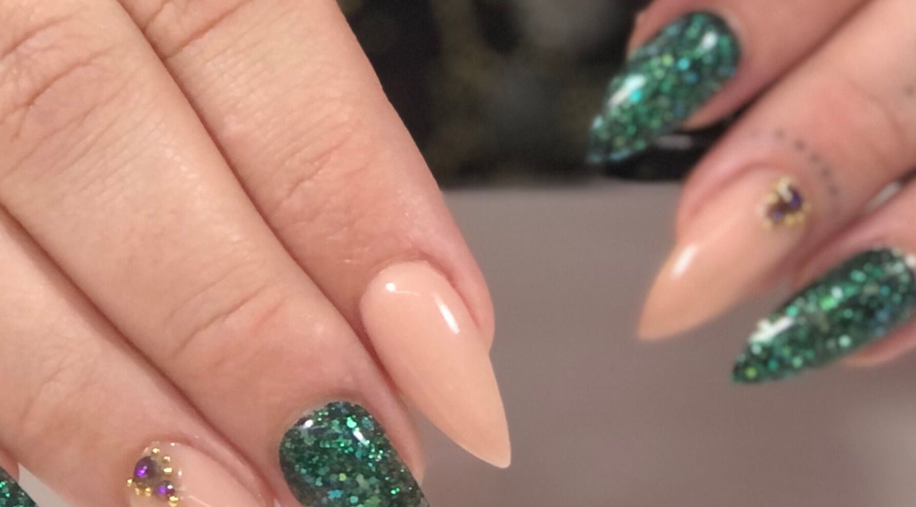 Elegant glitter nail art at Nails by D’zign, Benoni, Gauteng, ZA showcasing green and nude tones.