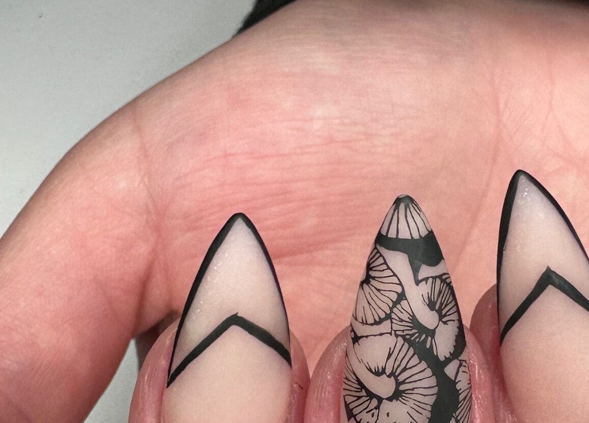 Elegant stiletto nails with black and white designs at Nails by D’zign, Benoni, Gauteng, ZA.