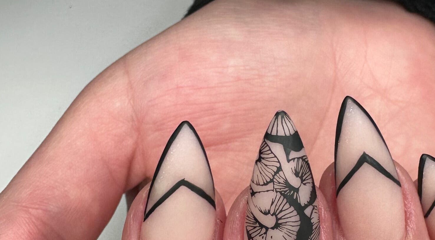 Elegant stiletto nails with black and white designs at Nails by D’zign, Benoni, Gauteng, ZA.