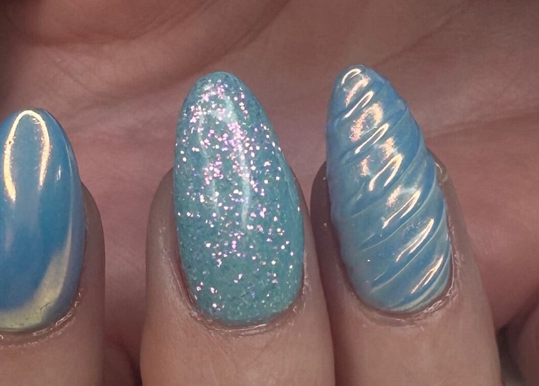 Glistening blue and glitter nails at Nails by D’zign, Benoni, Gauteng, ZA, showcasing unique designs.
