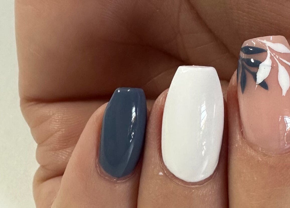 Beautiful nail art featuring blue, white, and floral designs at Nails by D’zign, Benoni, Gauteng, ZA.