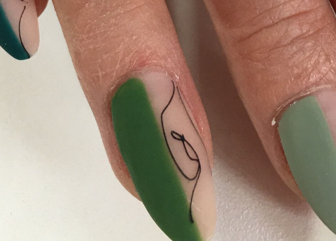 Intricate nail art design at Nails by D’zign, Benoni, Gauteng, ZA showcasing elegant green and black patterns.