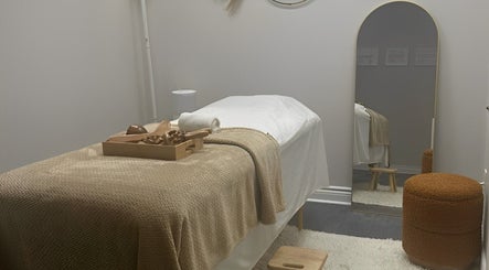 Relaxing therapy room at Lymphatic Drainage By Dayana, Toronto, Ontario, CA. Cozy setup with mirror and decor.