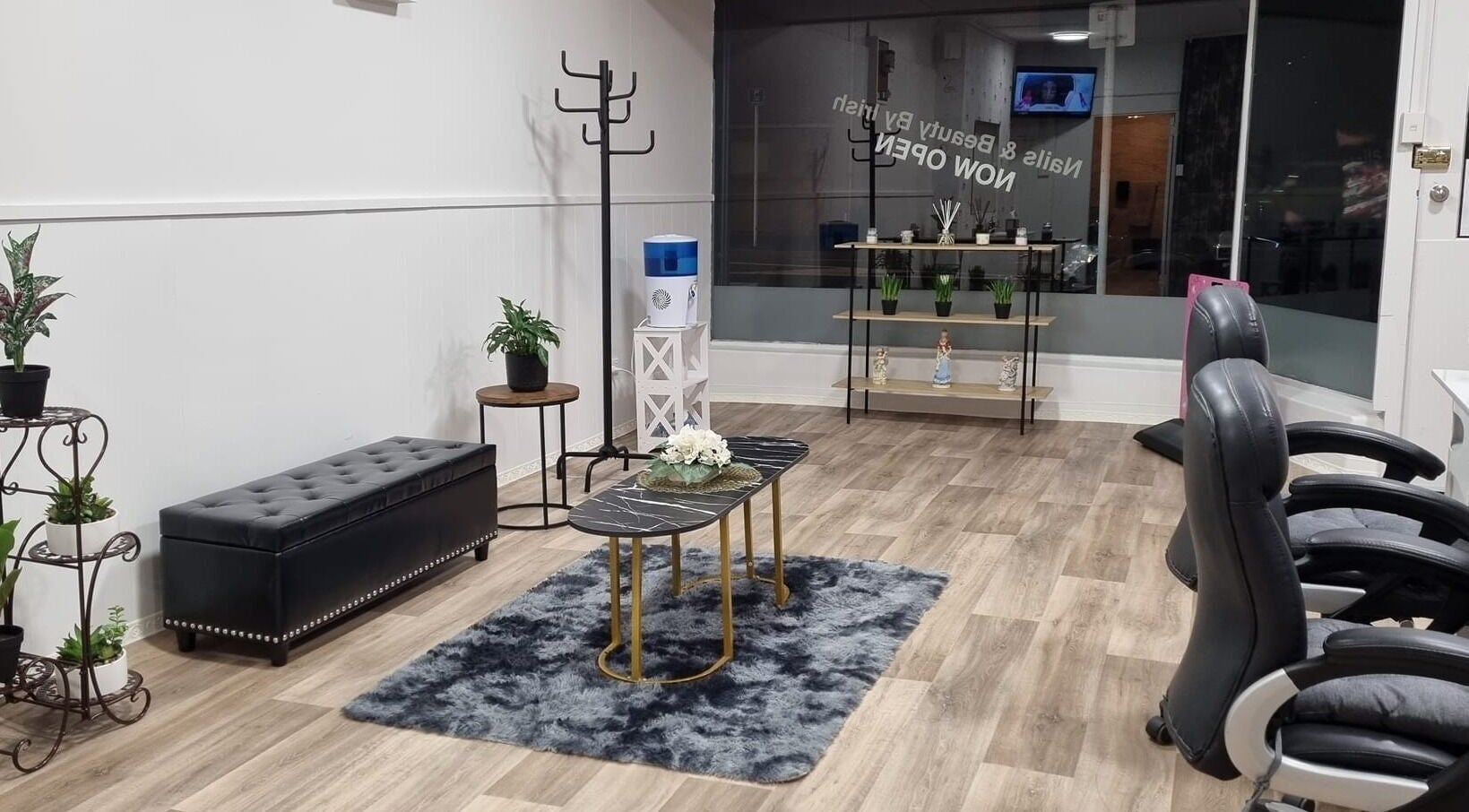 Chic interior of Nails and Beauty by Irish, Dunedin, Otago, NZ, featuring plush seating and modern decor.