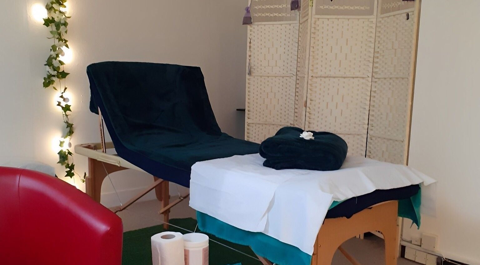Tranquil massage room at Rina's Massage & Reflexology in Aldershot, England, GB. Cozy setup with soft lighting.