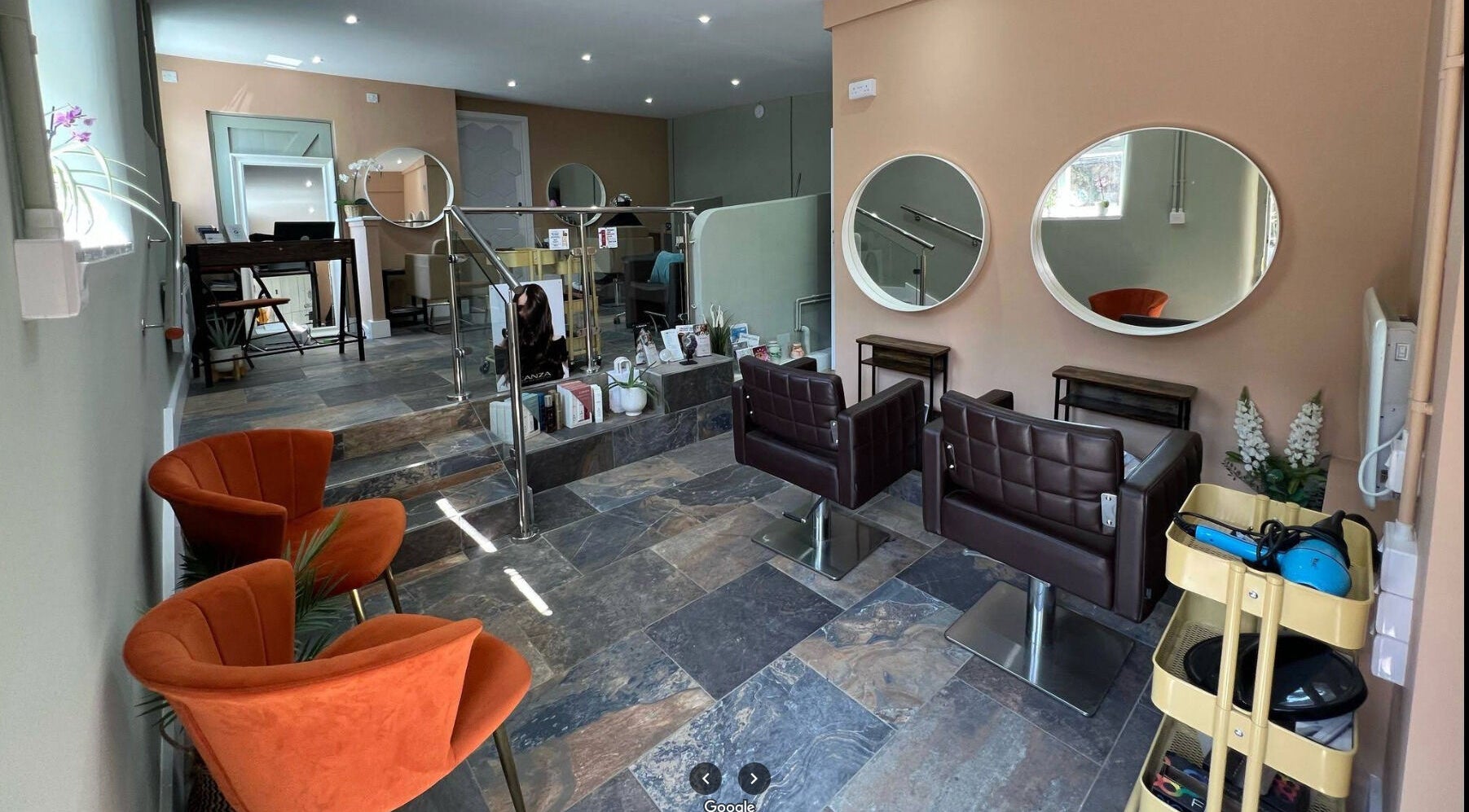 Interior of Shelwen Hair & Holistic, North Houghton, England, GB, featuring stylish mirrors and seating.