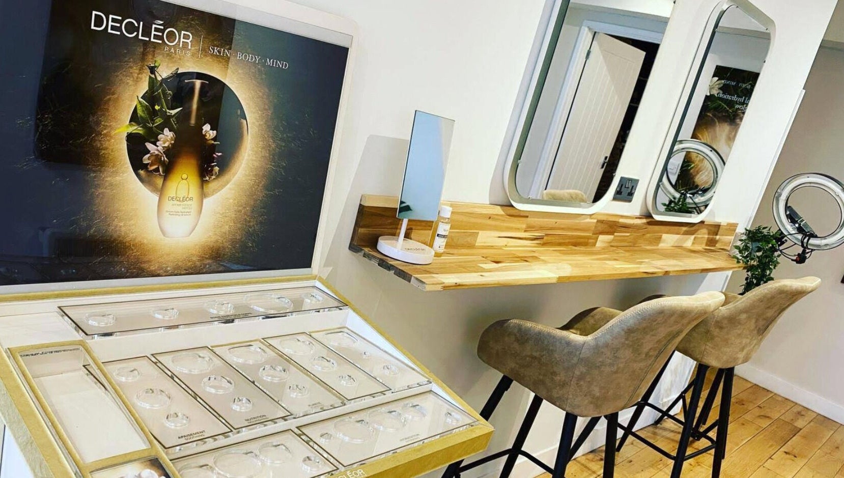 Elegant beauty setup at River and Rose, Dartmouth, England, GB with Decleor display and wooden vanity.