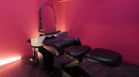 Luxurious massage room at Maris Gina, Shibuya City, Tokyo, JP featuring modern chair and warm lighting.