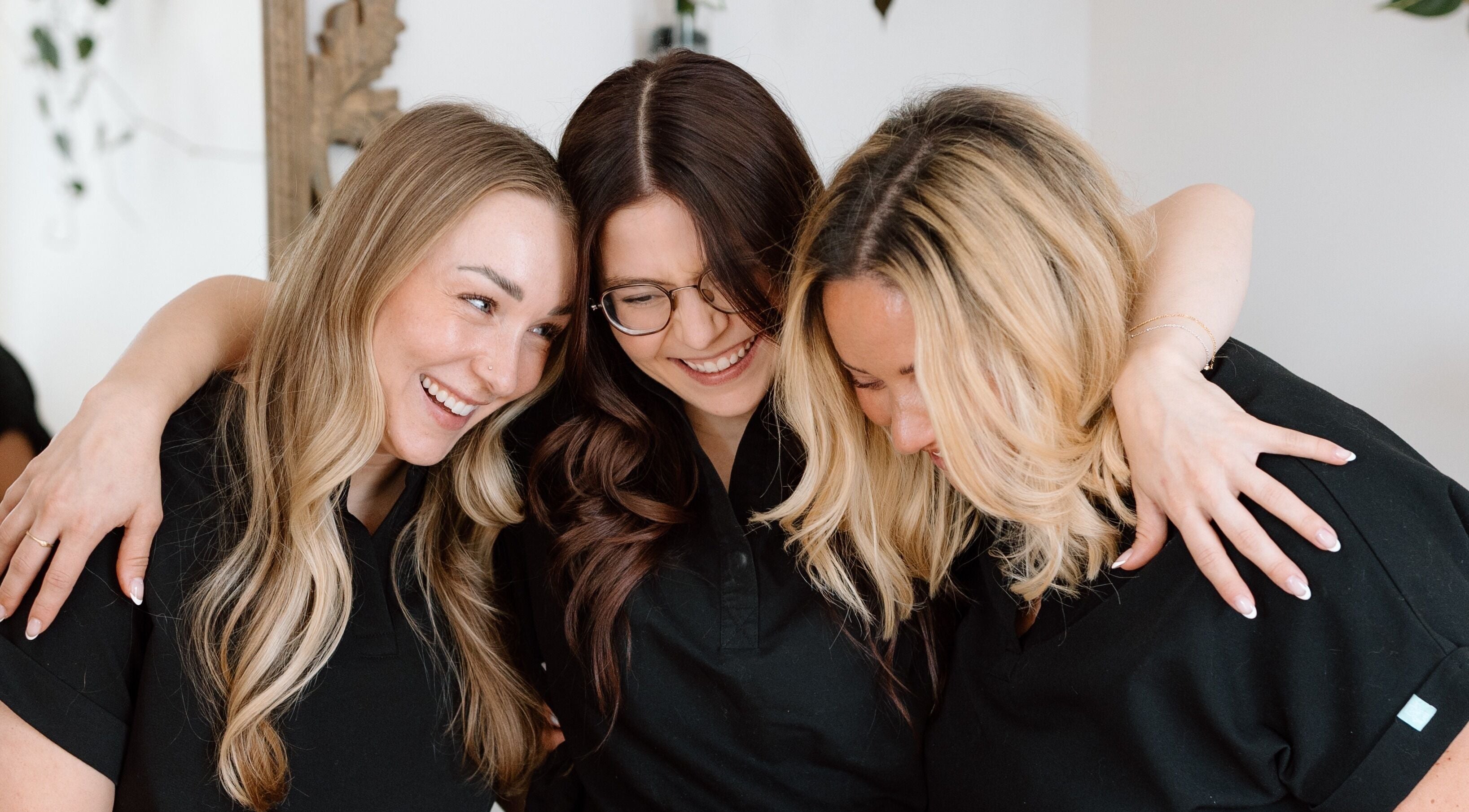 Smiling team at Sweet Beauty Esthetics in Kitchener, Ontario, CA, fostering a warm, inviting atmosphere.