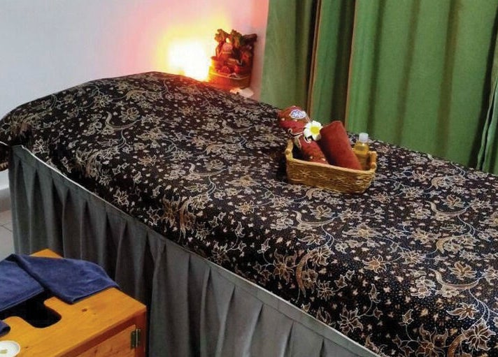 Relaxing massage table setup at Belaian Emas Spa, Putrajaya, Putrajaya, MY with elegant decor and warm lighting.