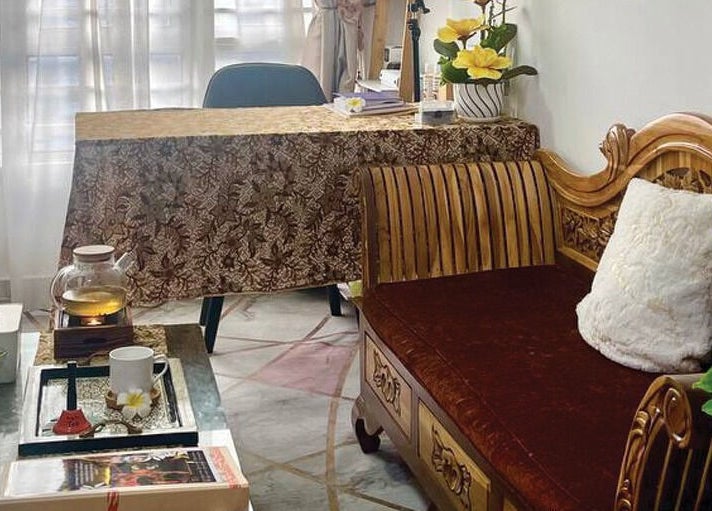 Cozy spa interior at Belaian Emas Spa, Putrajaya, showcasing a tea table and plush seating in Putrajaya, MY.