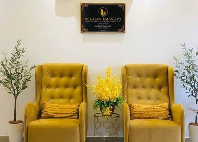 Luxurious seating at Belaian Emas Spa, Cybersouth, Selangor, MY with elegant yellow armchairs and decor.